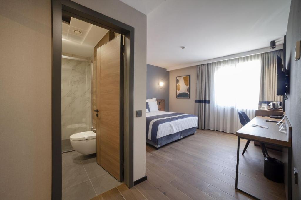 Postel nebo postele na pokoji v ubytování GRANBELLAHOTEL