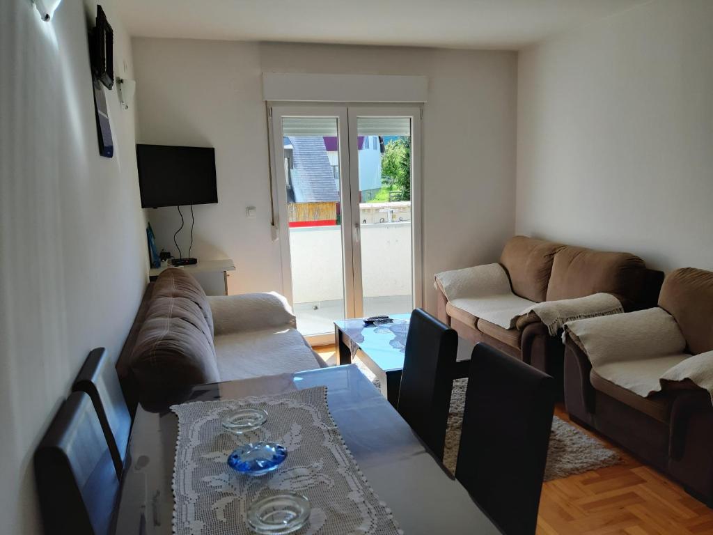 a living room with a couch and a table at Apartments Jovana in Žabljak