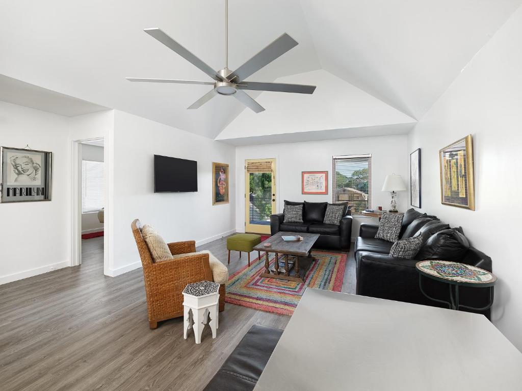 a living room with a couch and a ceiling fan at Folly Vacation Fantastic Vibe! Incredible Apt D in Folly Beach