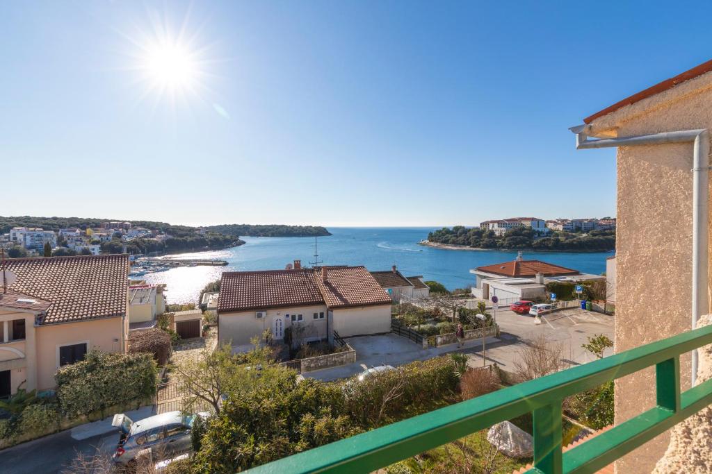 a view of the water from the balcony of a building at Horizont view apartment in Pula