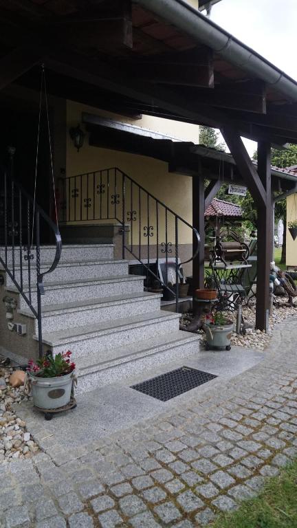 a set of stairs in a building with potted plants at Heckes Ferienwohnung in Schöneiche