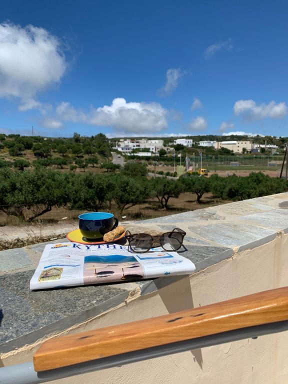 een bril en een surfplank op een richel bij Attik residence in Livadi