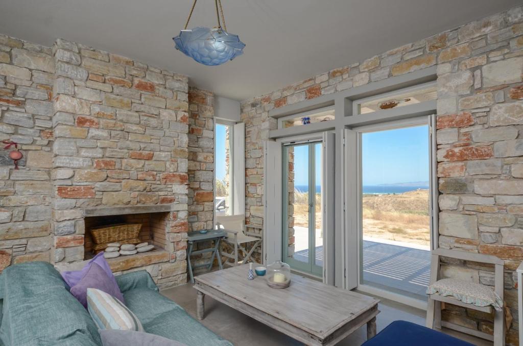 a living room with a stone wall at Sunshine villa in Mikri Vigla