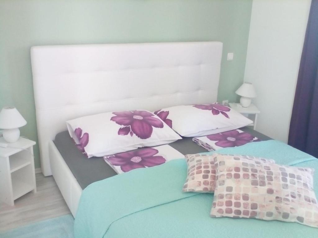 a bedroom with two beds and two pillows at Ana Rooms in Krk