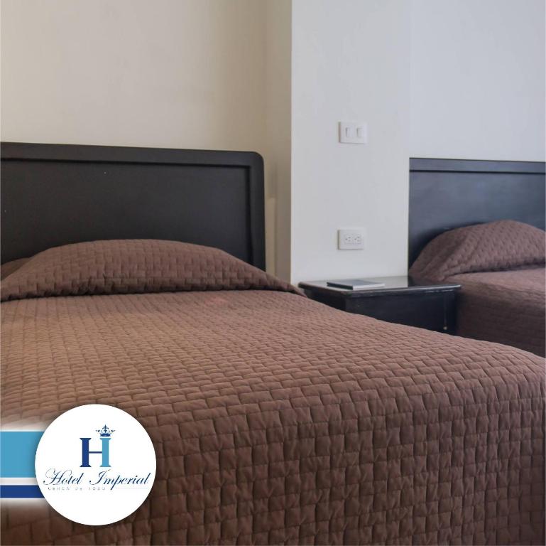 Postel nebo postele na pokoji v ubytování Hotel Imperial