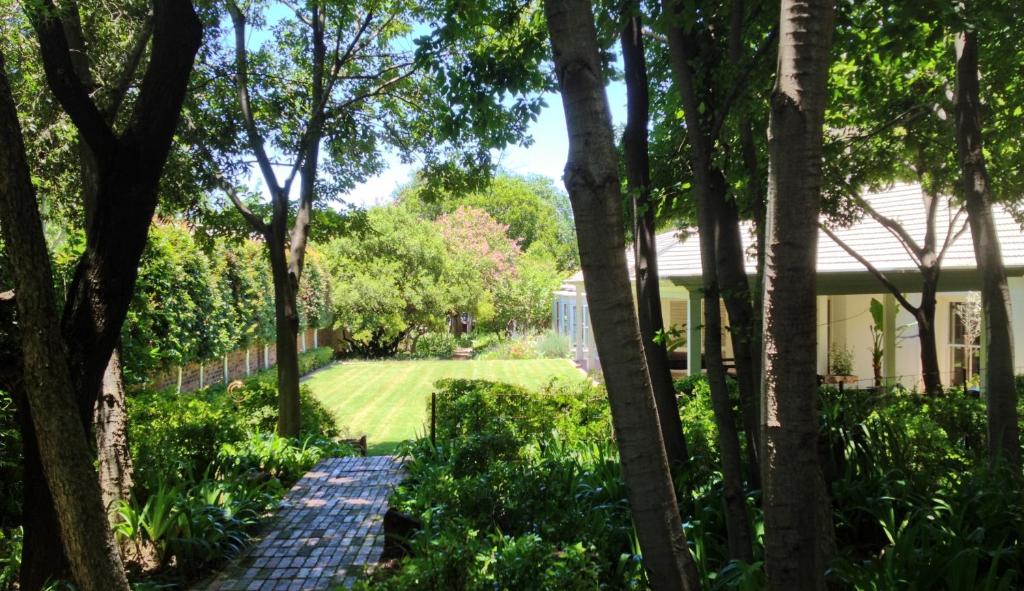 uma vista para um jardim a partir da casa em Guest House at 118 by PWM Architects em Joanesburgo