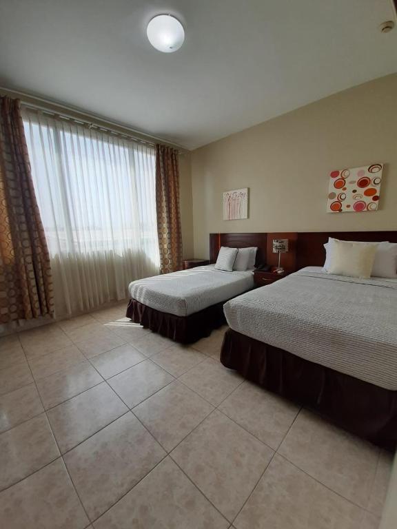 Postel nebo postele na pokoji v ubytování Hotel Air Suites