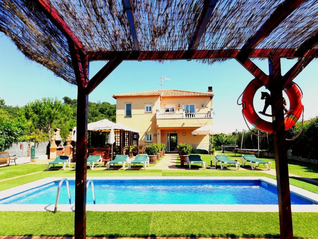 a view of a pool and a house at Holiday Home Cardona in Lloret de Mar