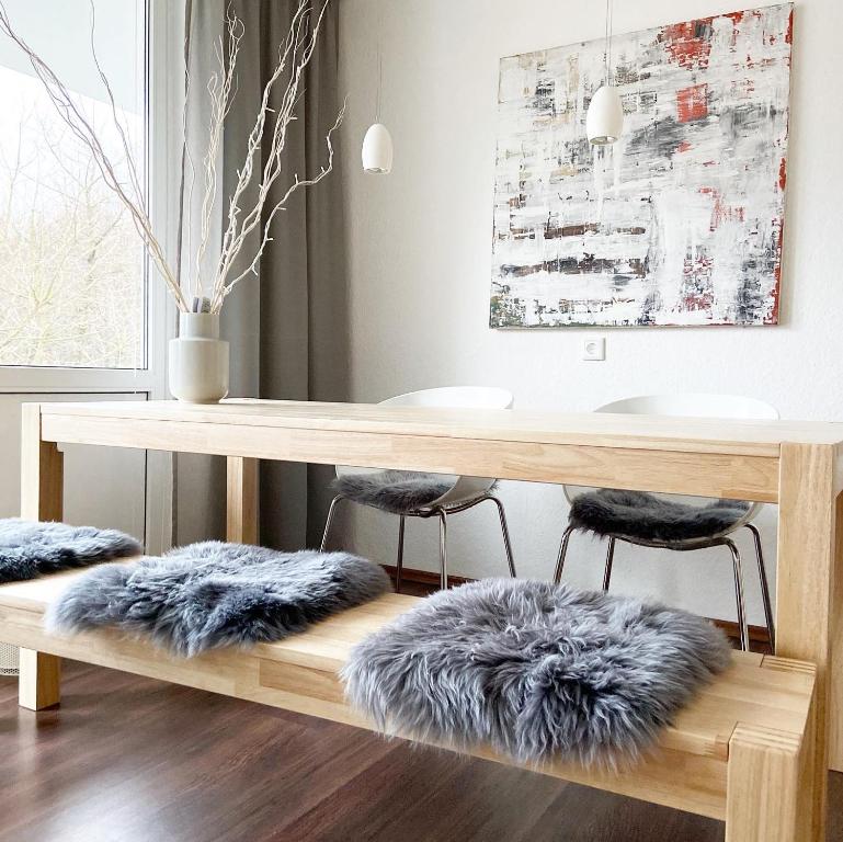 a dining room table with a fur rug under it at Harz is calling in Hahnenklee-Bockswiese