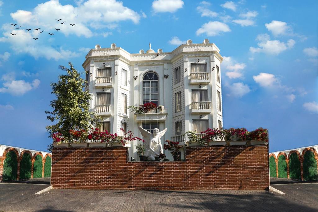 斋浦尔Hotel Magenta Jaipur的前面有雕像的白色建筑
