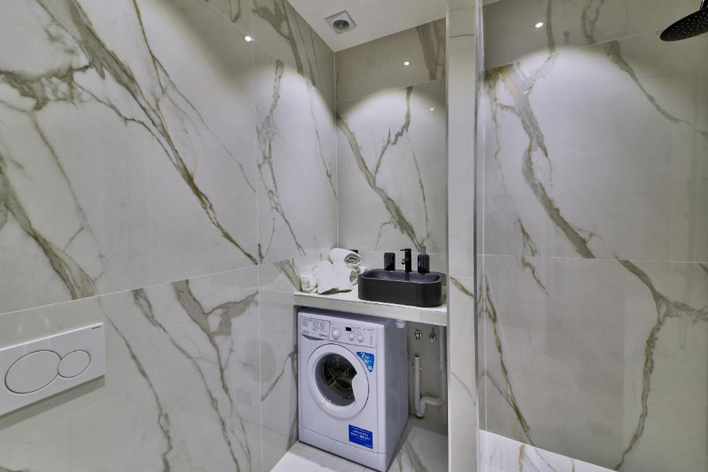 a bathroom with a washer and dryer in it at 98 - Urban Arts et Métiers in Paris