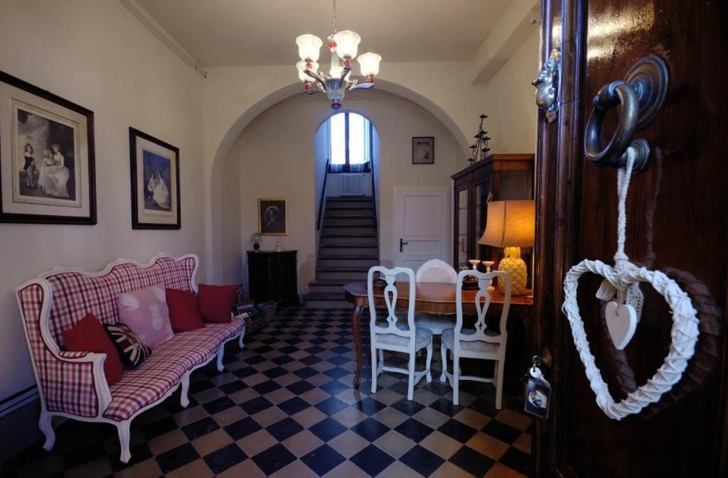 a living room with a table and chairs and a staircase at B&B Cimamori in Poggibonsi