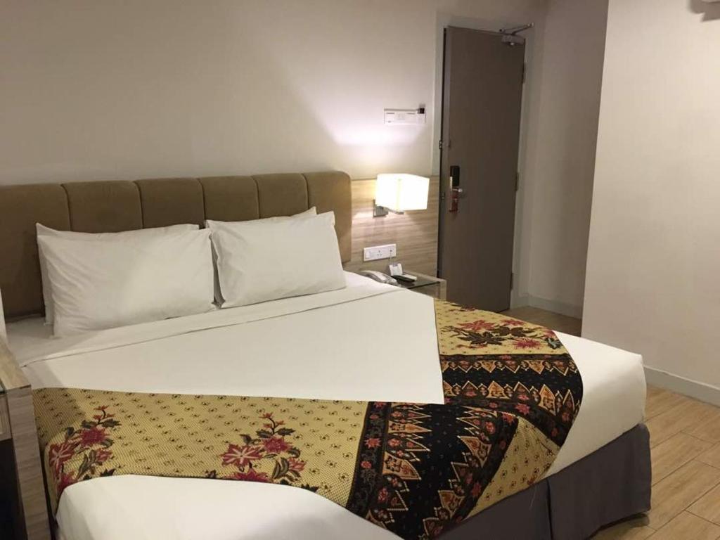 Postel nebo postele na pokoji v ubytování NU Hotel @ KL Sentral