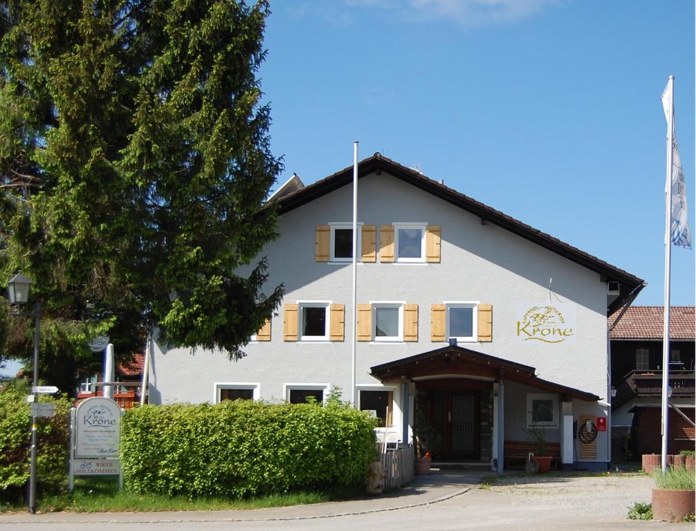a white building with a sign in front of it at Landhotel Krone in Oberreute