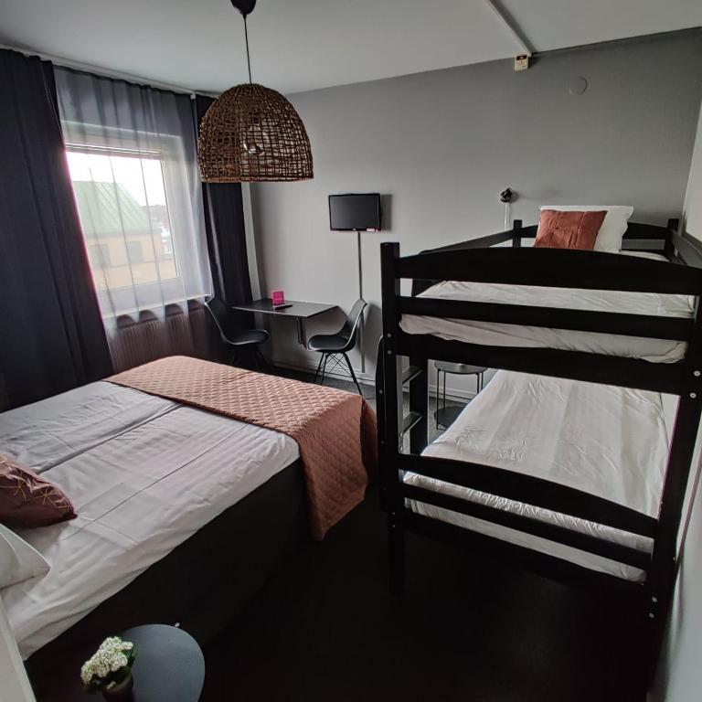 Postel nebo postele na pokoji v ubytování CarlstadCity H Boutique Hotell
