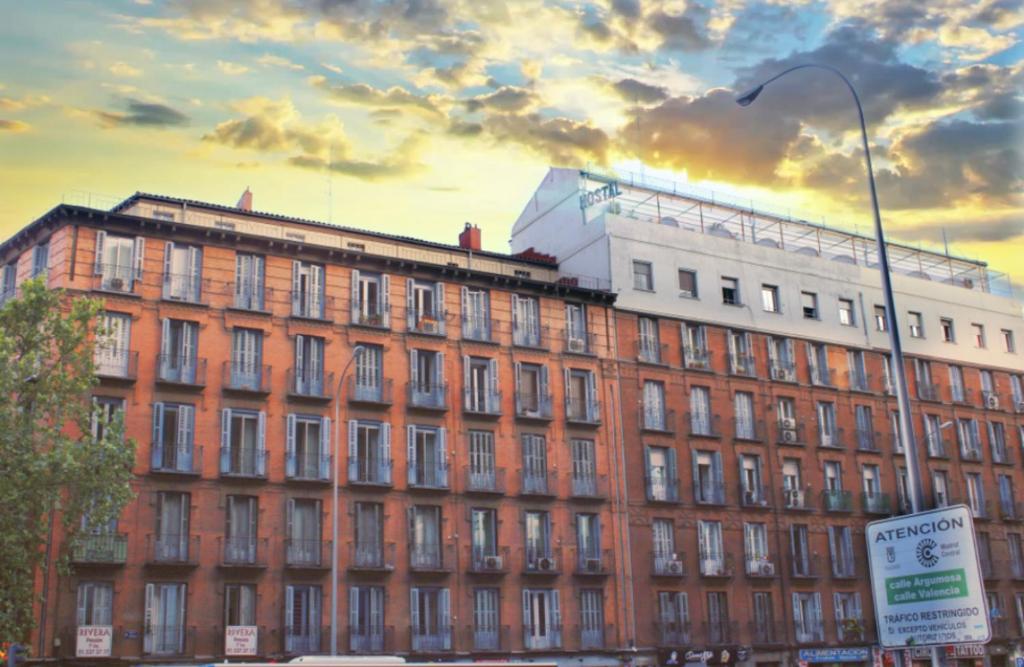 a large brick building with a street light in front of it at Metropolitan Atocha in Madrid