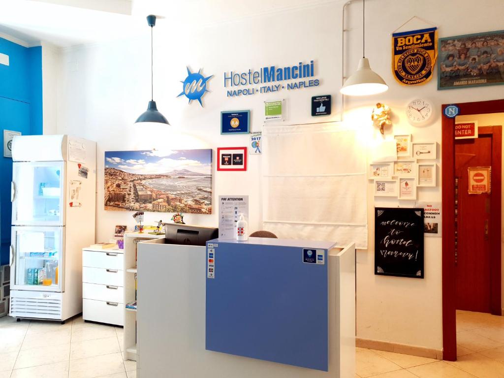 a kitchen with refrigerators and a refrigerator in a store at Hostel Mancini Naples in Naples