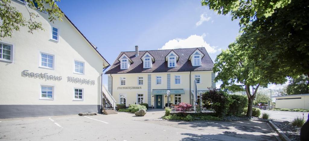 a large white building with a black roof at Gasthaus & Pension Mohren in Pfullendorf