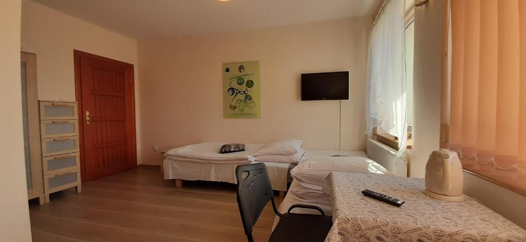 Postel nebo postele na pokoji v ubytování Słoneczny Dom pokoje i apartament na wynajem
