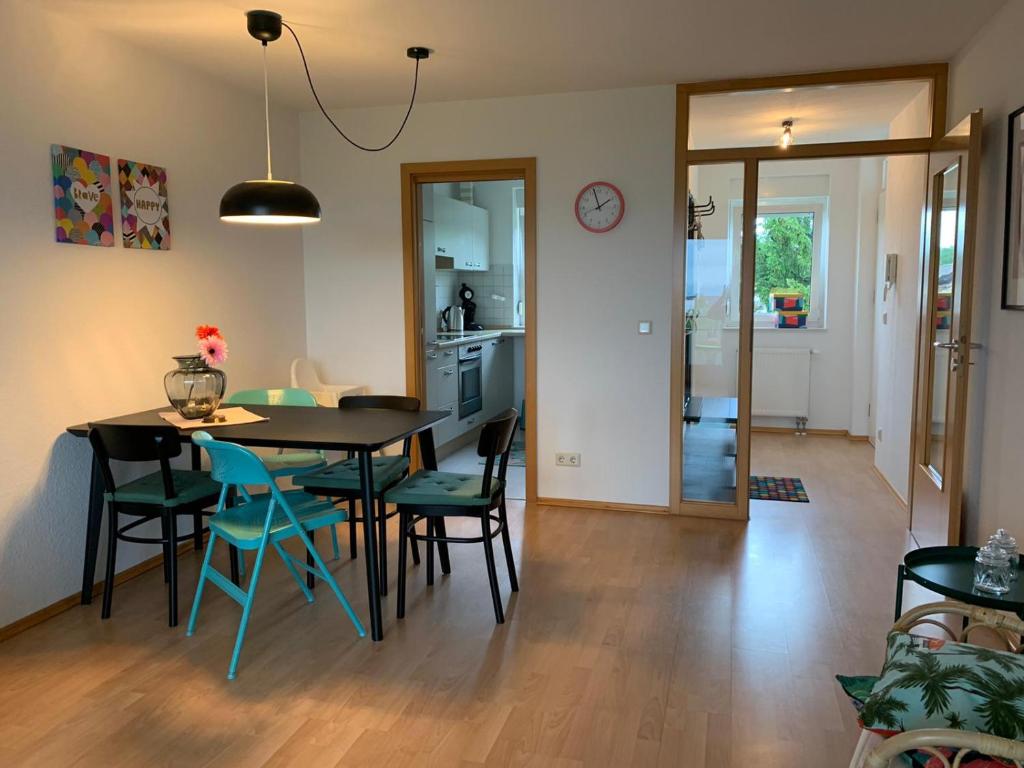 a kitchen and dining room with a table and chairs at Anytime - Ferienwohnung Rita in Friedrichshafen in Friedrichshafen