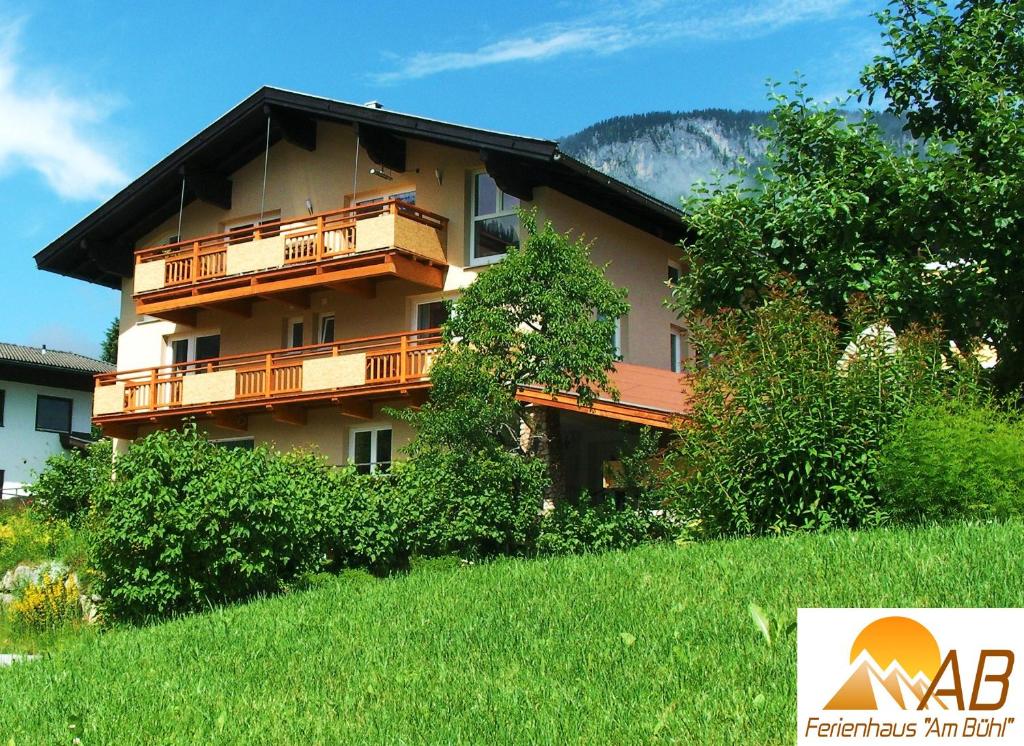 a building with wooden balconies on the side of it at Ferienhaus AB in Söll
