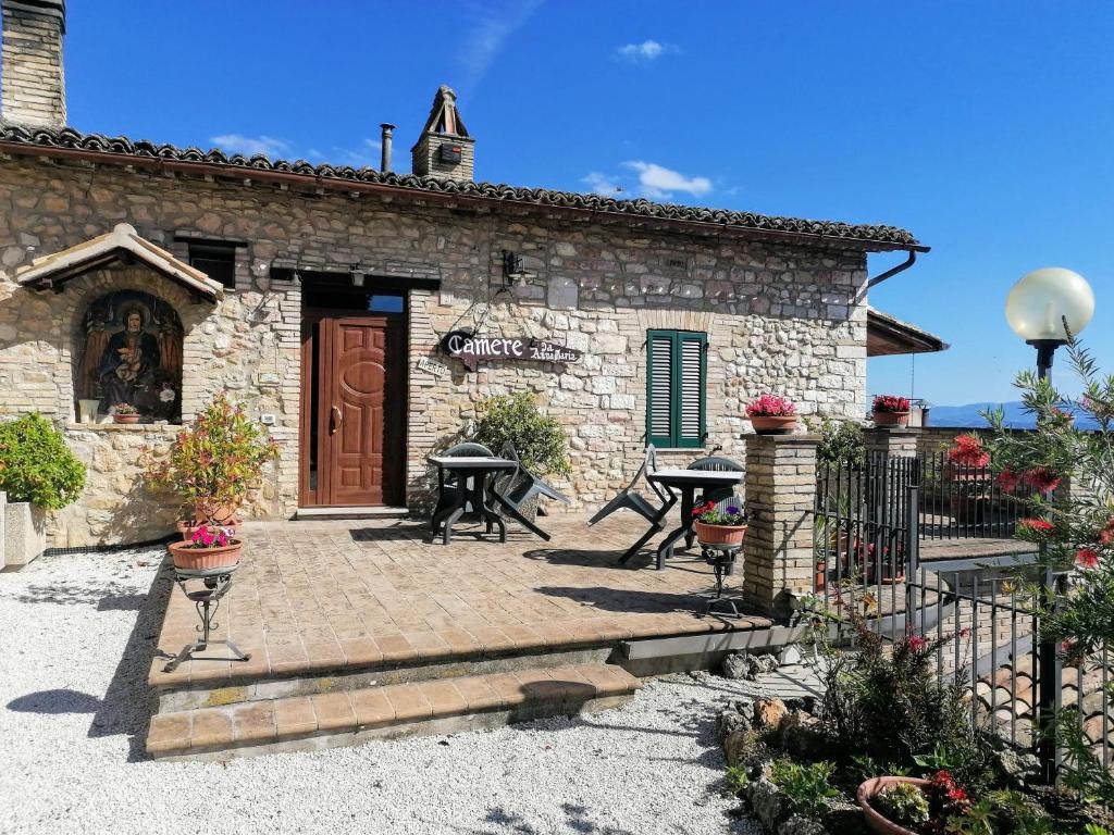 a stone building with a patio in front of it at Camere da Anna Maria in Assisi