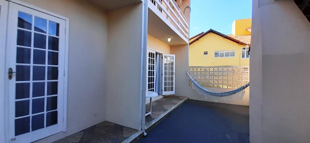 a hallway of a house with doors and a balcony at Parada dos Golfinhos in Florianópolis