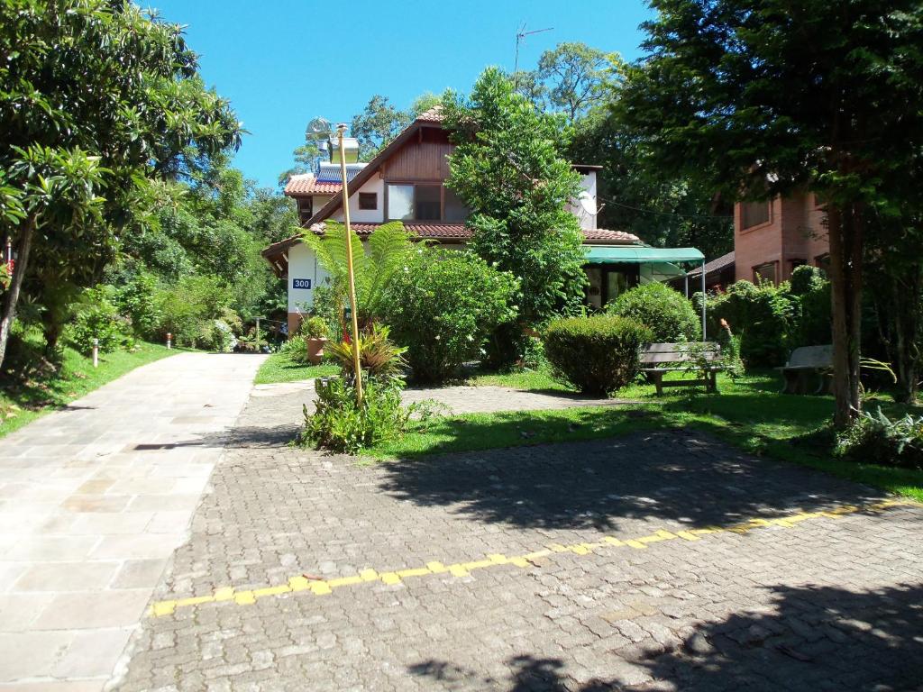 a brick road in front of a house at Ex Pousada Vale do Bosque - Aluguel por temporada in Gramado