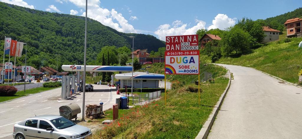 a car parked at a gas station next to a road at Prenociste DUGA in Užice