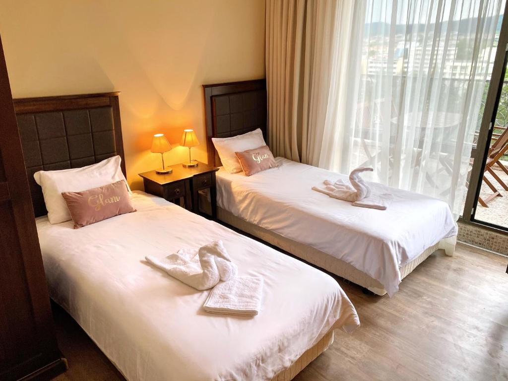 Postel nebo postele na pokoji v ubytování Royal Beach Premium