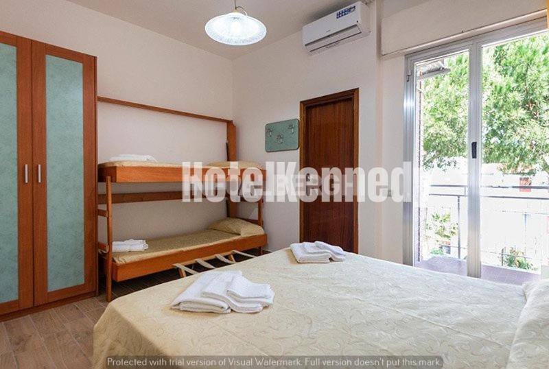 Postel nebo postele na pokoji v ubytování Hotel Kennedy