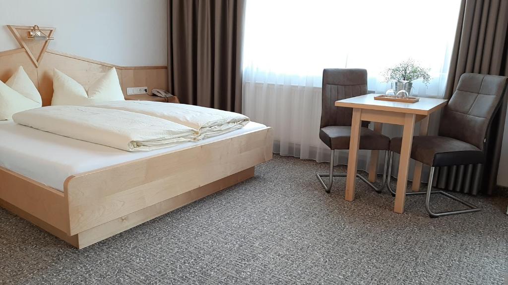 Postel nebo postele na pokoji v ubytování Hotel Garni Bergland