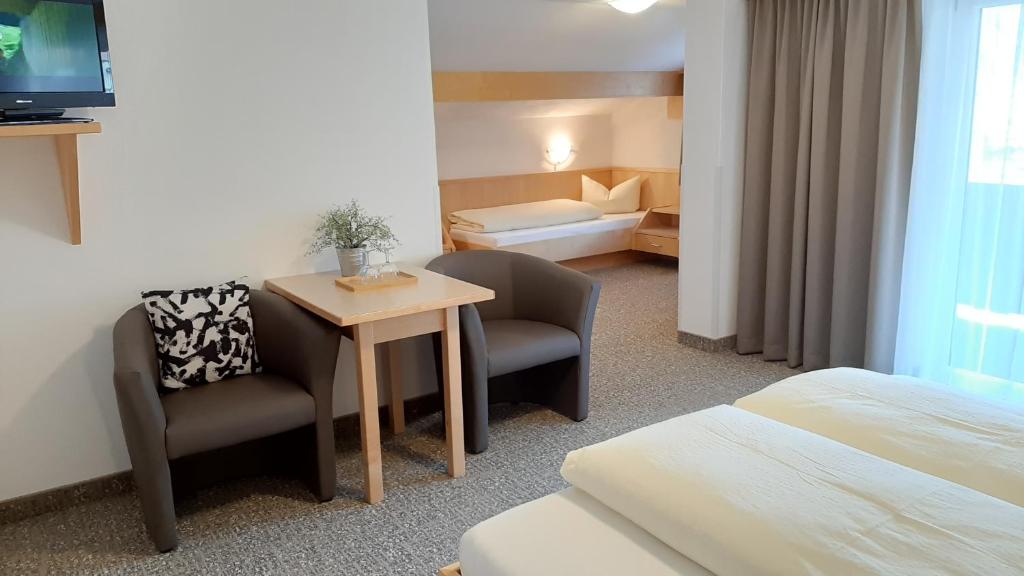 Postel nebo postele na pokoji v ubytování Hotel Garni Bergland