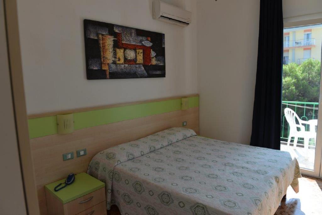 Postel nebo postele na pokoji v ubytování Hotel Verdi