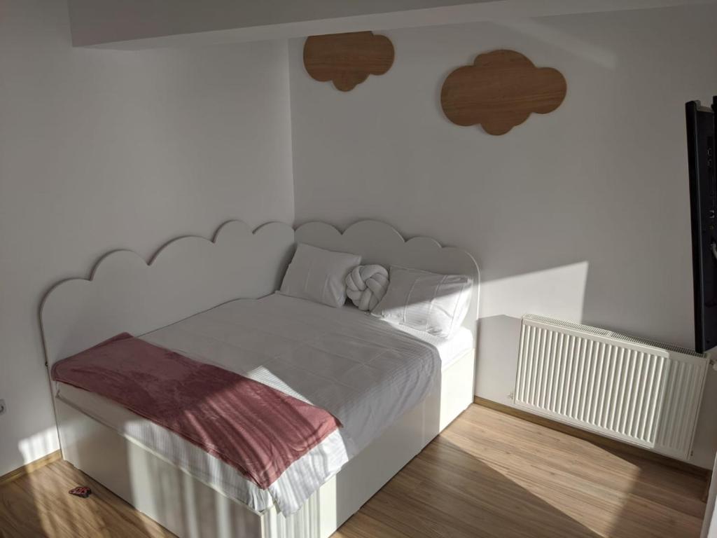 una camera con letto bianco e testiera metallica di Mamaia centru Kids friendly apartament a Mamaia