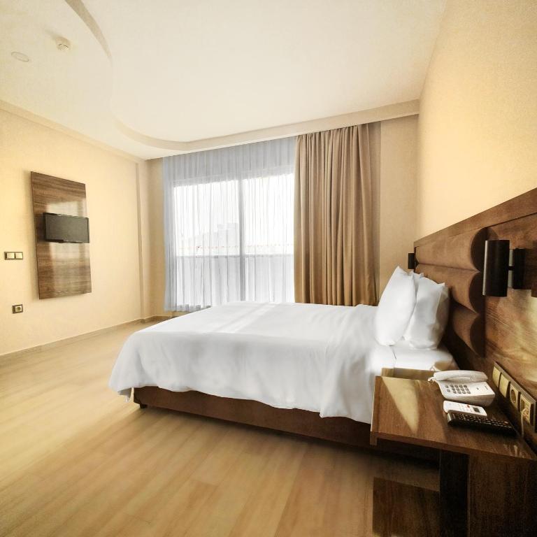 Postel nebo postele na pokoji v ubytování Ozgur Bey Spa Hotel