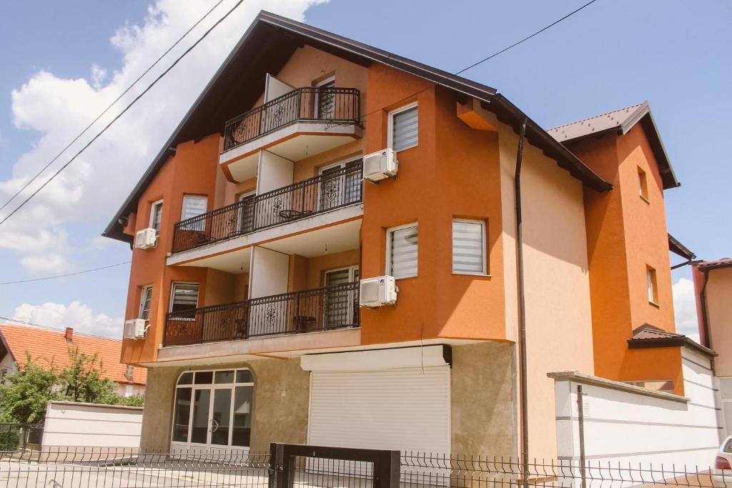 in einem orangefarbenen und weißen Gebäude mit Balkon in der Unterkunft Golden House in Sarajevo