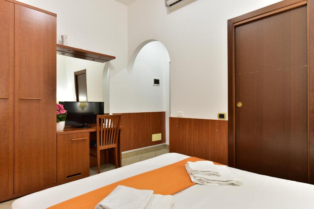 a bedroom with a bed and a desk and a chair at B&B Termini in Rome