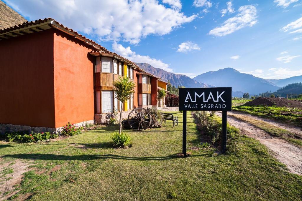 a sign in front of a house with a sign for a villa at Amak Valle Sagrado in Urubamba