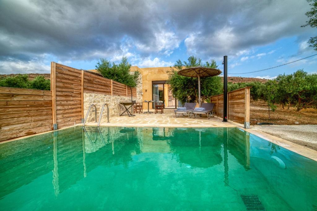 een zwembad voor een huis bij Olive Luxury Suites - ADULTS ONLY in Kamilari