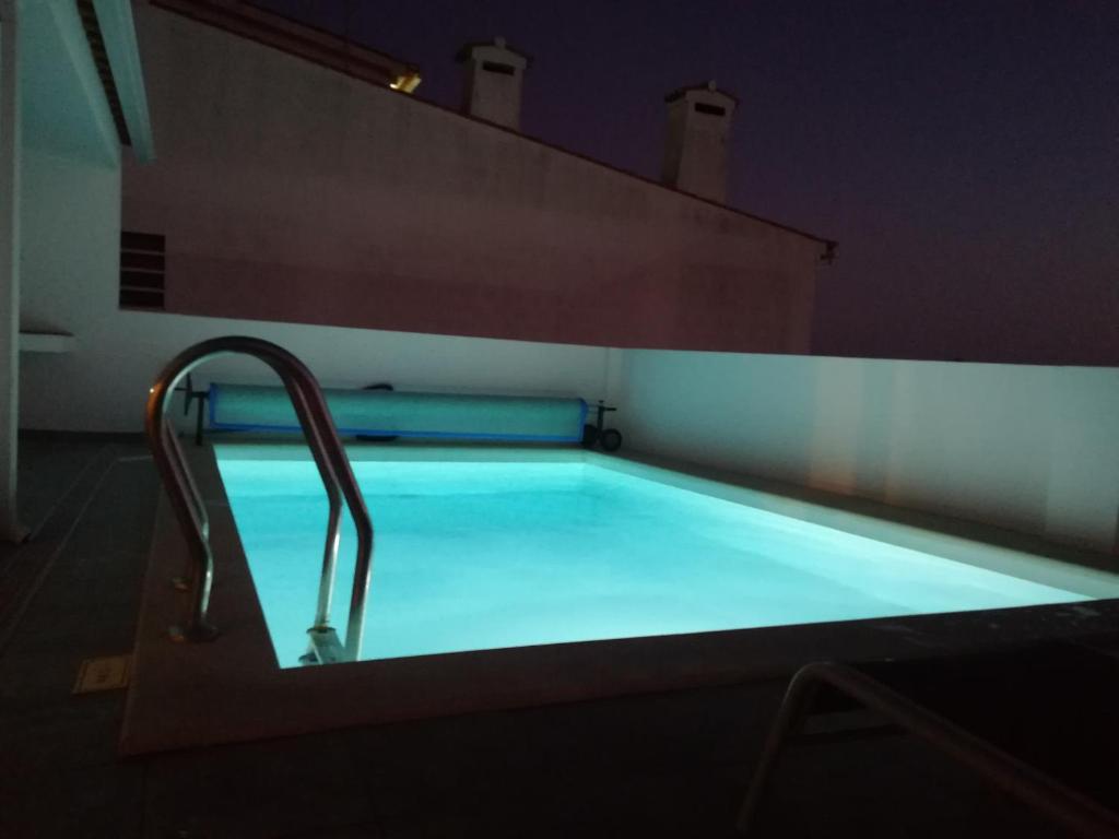 a swimming pool with a faucet in a room at PoolSeaView Spacious House in Atouguia da Baleia