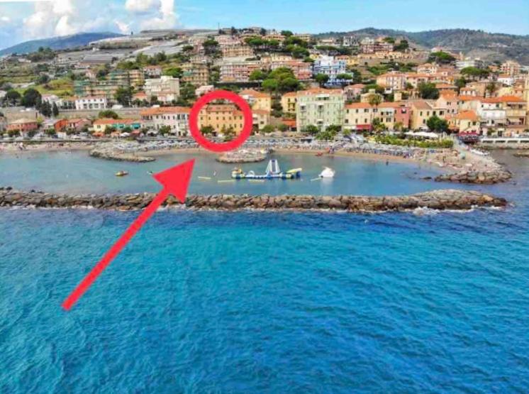 an island in the water with a red arrow at Casa Nanà in Santo Stefano al Mare