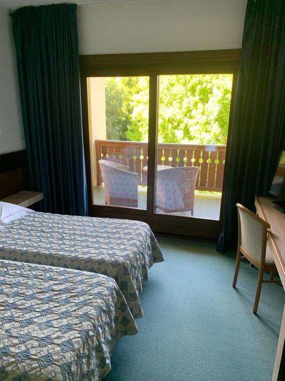 Uma cama ou camas num quarto em Hotel Miage