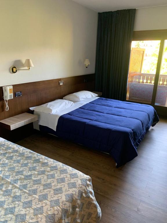 Uma cama ou camas num quarto em Hotel Miage