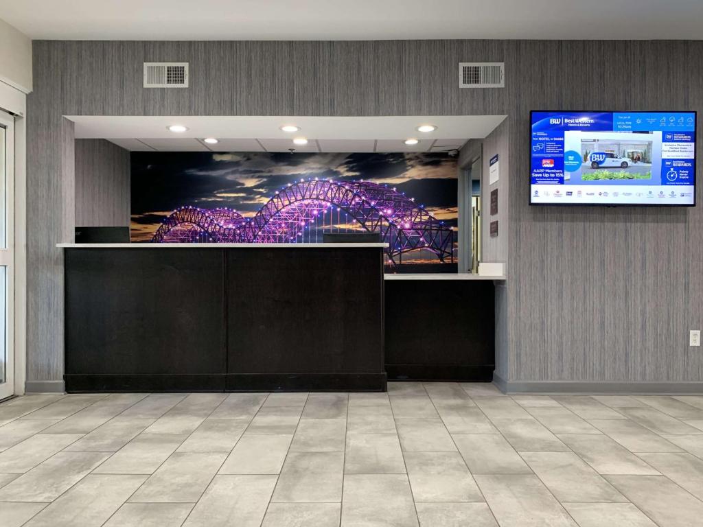 a lobby with a large screen in a building at Best Western Plus Olive Branch Hotel & Suites in Olive Branch