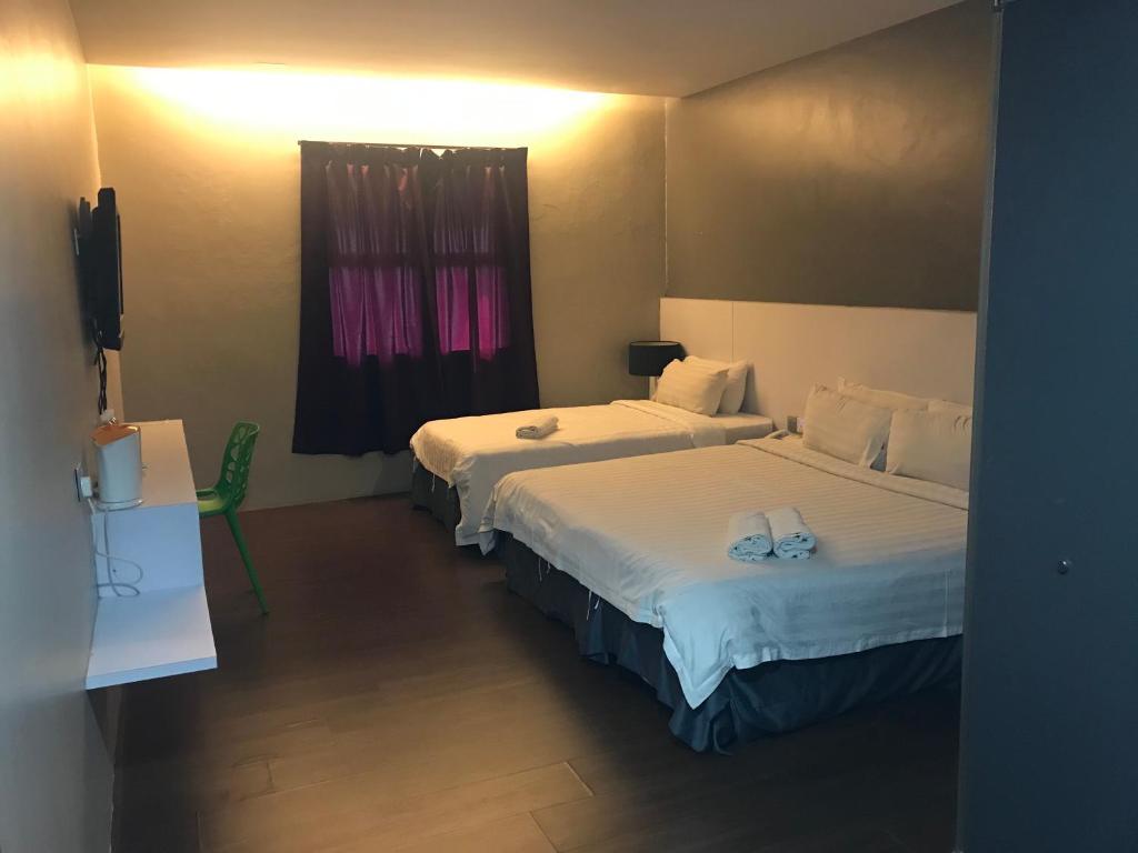 Postel nebo postele na pokoji v ubytování Chariton Hotel Ipoh