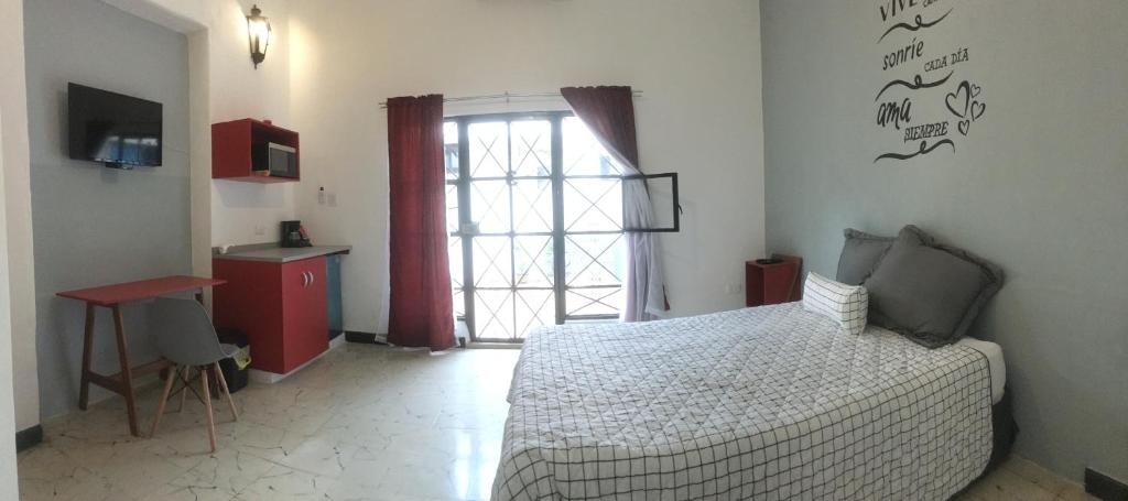 Llit o llits en una habitació de Suites del Sureste - Mérida