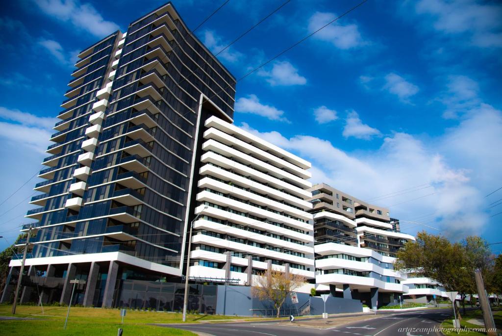 a tall building in a parking lot at Modern, Clean, Luxury at the Right Price..... in Maribyrnong
