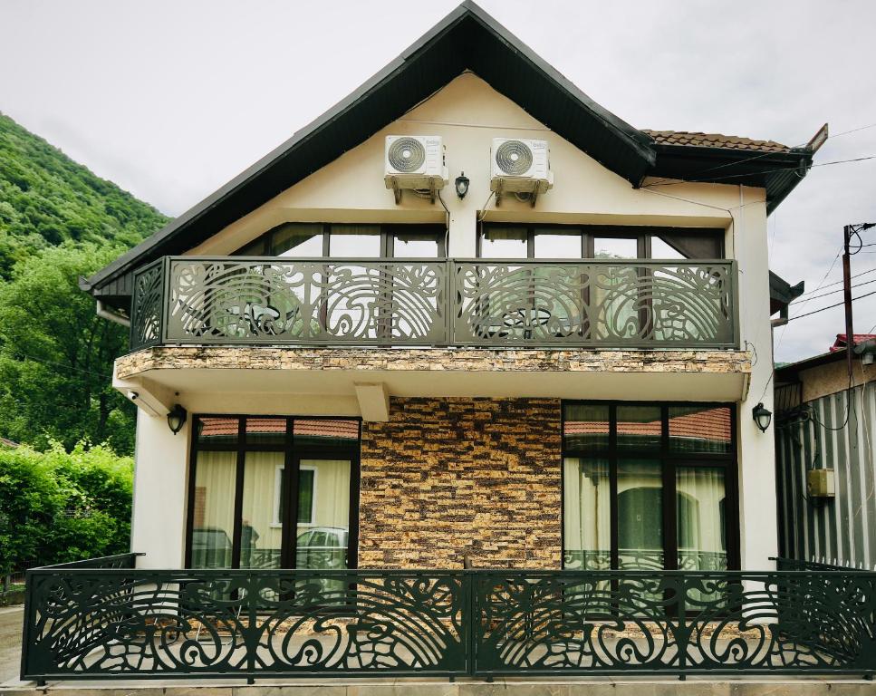 a house with a balcony with speakers on it at Casa Golopența in Băile Herculane