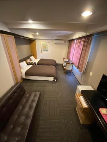 Postel nebo postele na pokoji v ubytování Hotel Yutaka Wing